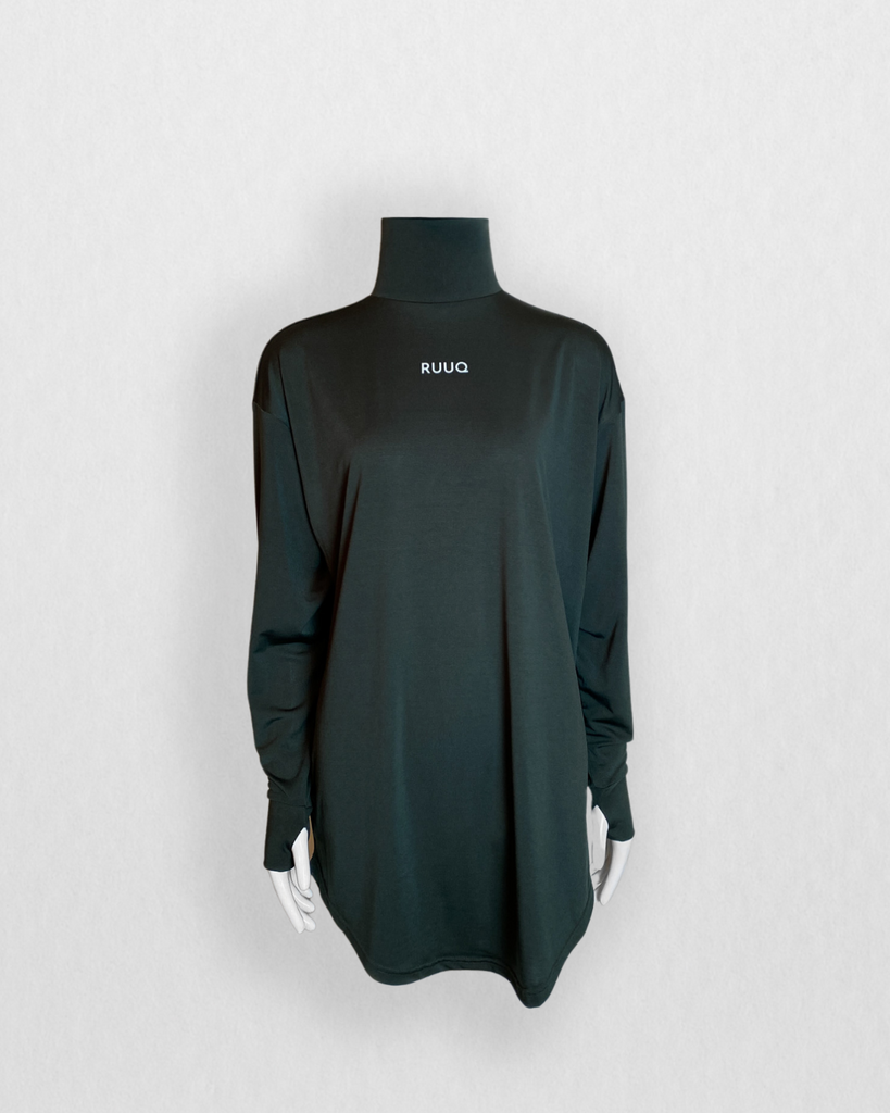 Oversized Long sleeve Top with Mock Neck in color Forest Green. Thumb holes at cuff. Curved scoop hem covers past mid thigh. RUUQ logo at front center and RUUQ emblem at back center.